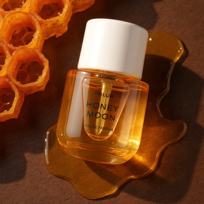 Phlur Honey Moon perfume styled in a warm, golden honeycomb setting