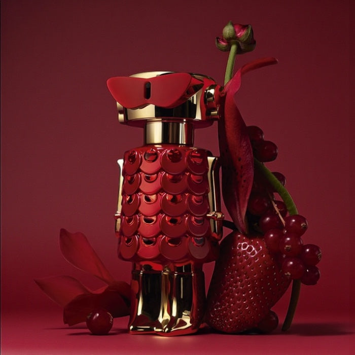 Rabanne Fame In Love perfume sample styled in soft pink and red tones to reflect its playful strawberry sweetness.