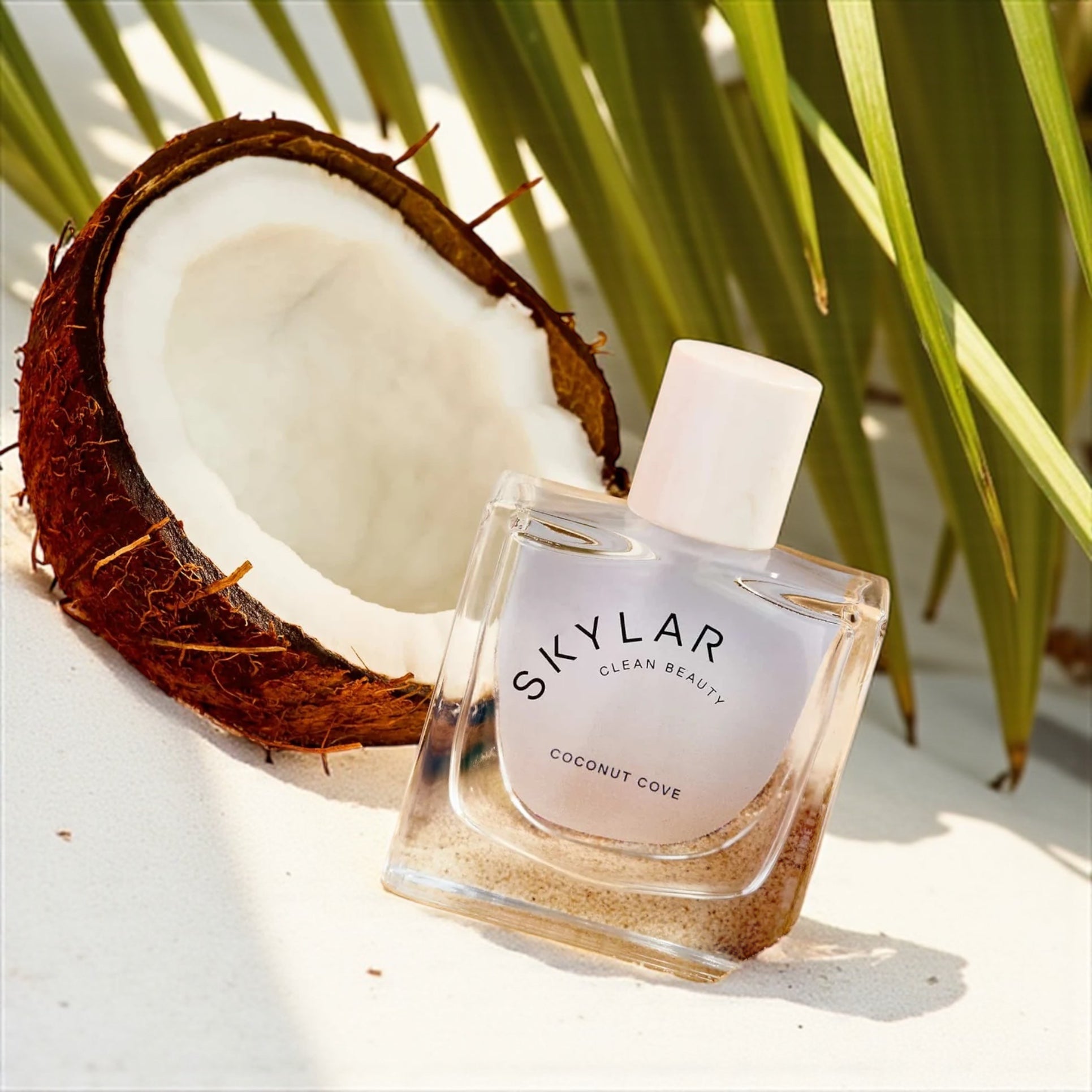 Skylar Coconut Cove perfume sample – coconut, bergamot and ocean-inspired notes styled in a tropical coastal setting.