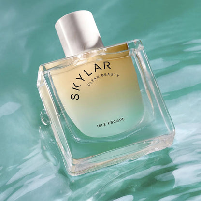 Isle Escape perfume sample – bergamot, sandalwood and amber notes styled in a bright coastal beach setting.