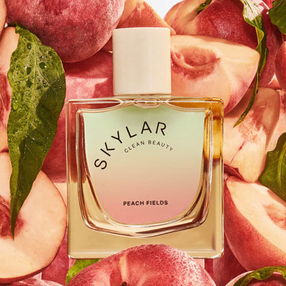 Skylar Peach Fields perfume sample – white peach, osmanthus and sandalwood notes styled in a bright, sunlit orchard setting.