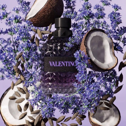 Valentino Uomo Born In Roma Purple Melancholia perfume styled in a dark, elegant setting with lavender and coconut